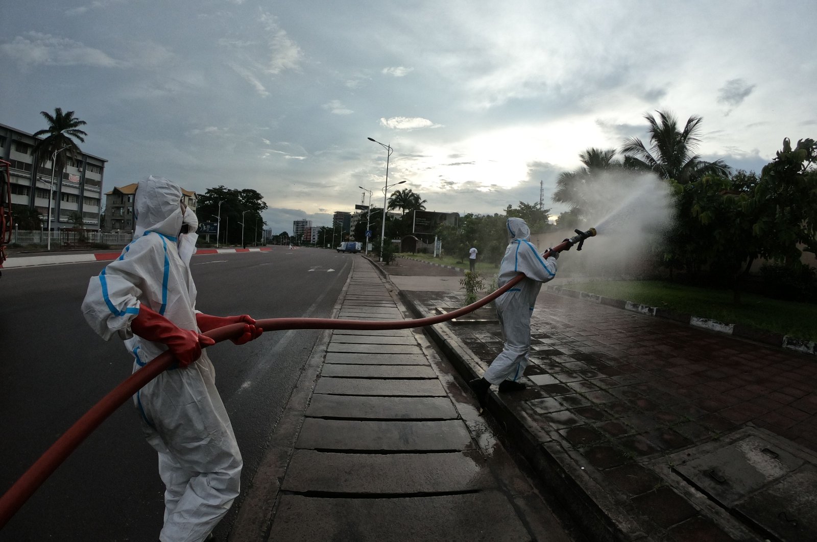Congolese firemen begin disinfecting operations in state buildings and public spaces in the Gombe district of Kinshasa, April 12, 2020. (AFP Photo)