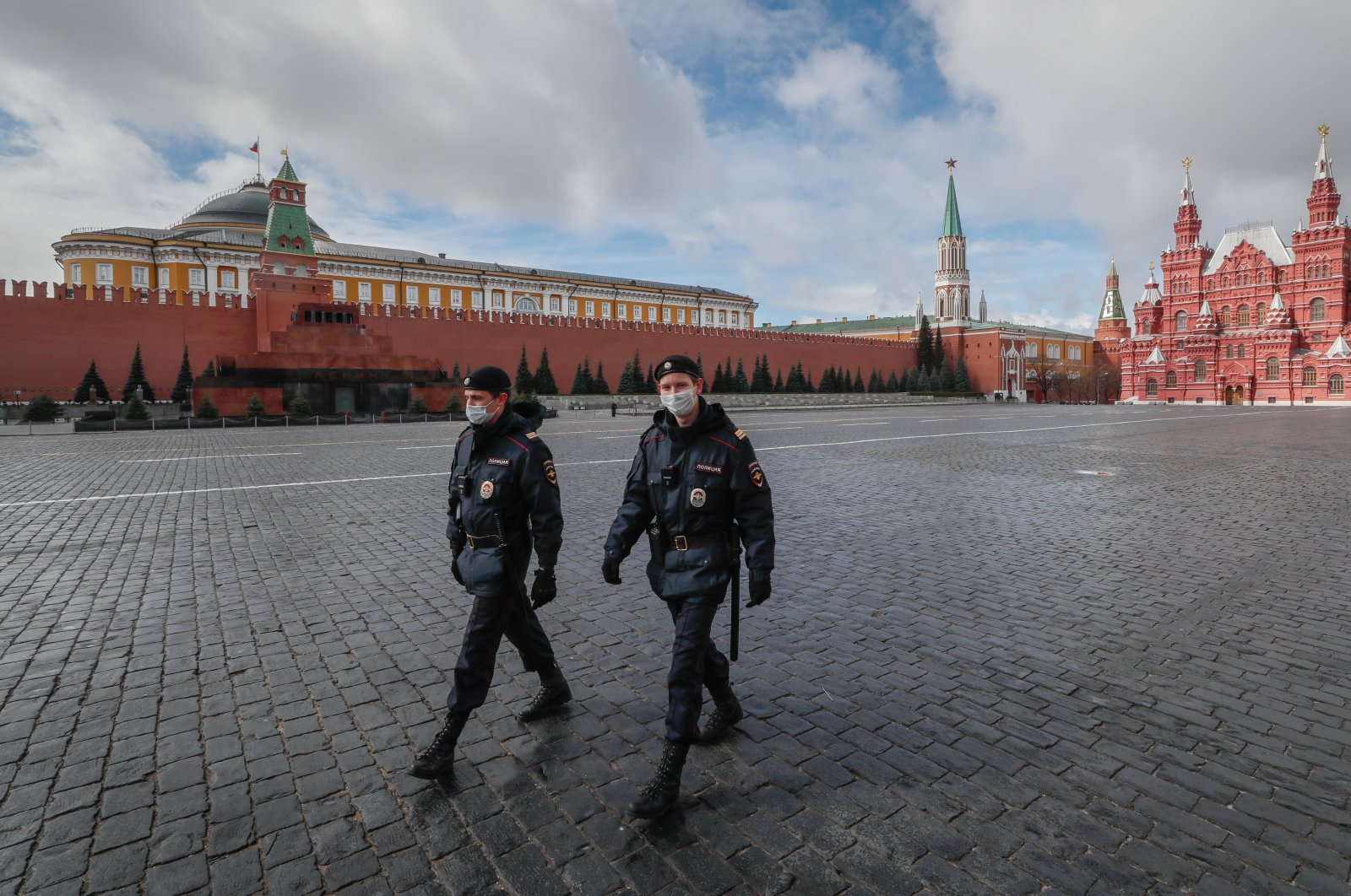 Police officers wearing protective masks walk on the Red Square in front of the Kremlin in Moscow, Russia, 17 April 2020. (EPA-EFE/YURI KOCHETKOV Photo)