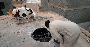 A Libyan checks the site of shelling on the residential area of Arada in the capital Tripoli on April 14, 2020. (AFP)