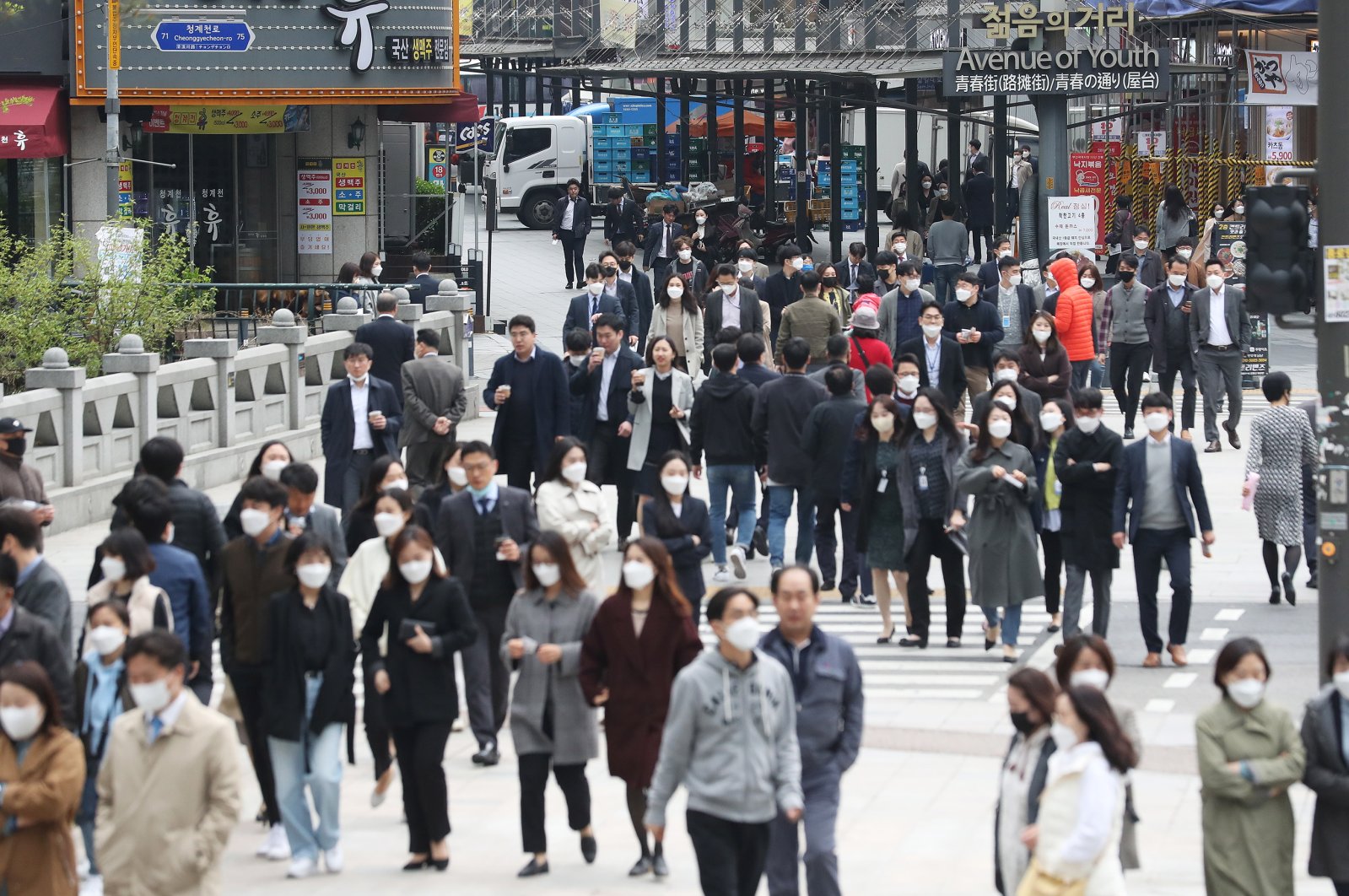 People wearing protective masks walk in Jongno Ward, Seoul, South Korea, April 20, 2020. (EPA Photo)
