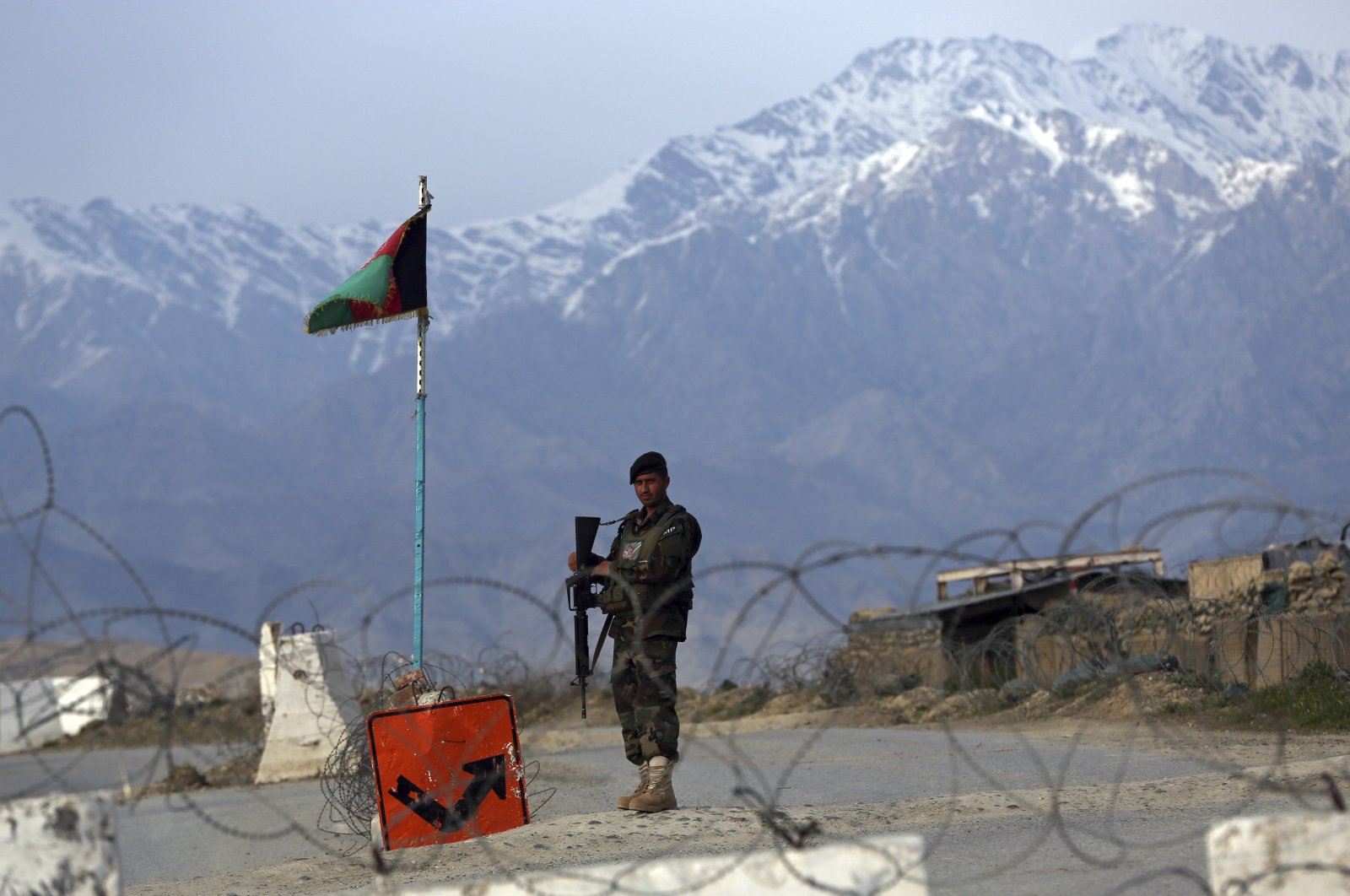 An Afghan National Army soldier stands guard at a checkpoint near the Bagram base north of Kabul, Afghanistan, April 8, 2020. (AP Photo)