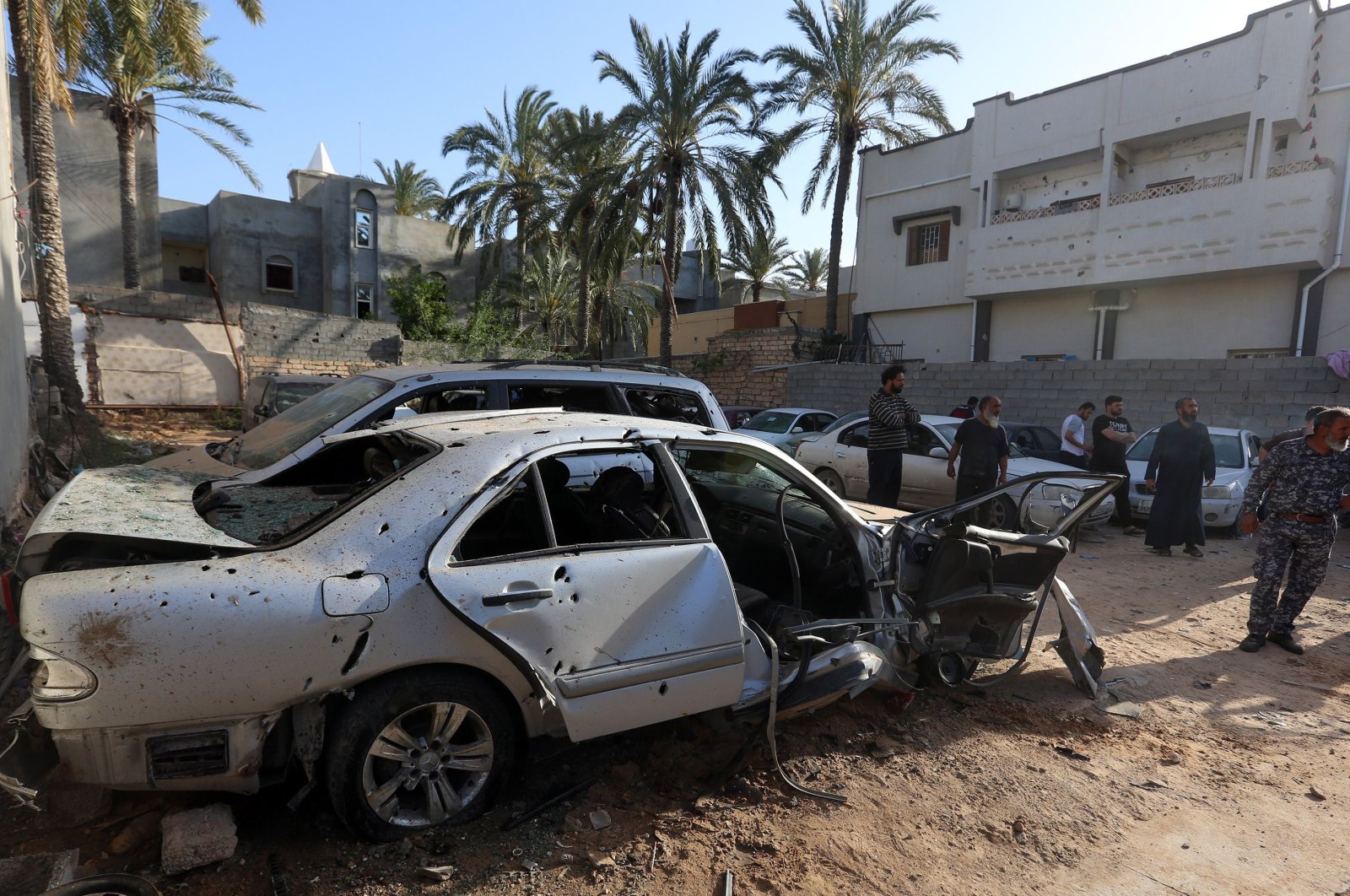 Libyans check the site of shelling on the residential area of souq al-Gomaa, north of the Libyan capital Tripoli, on April 17, 2020. (AFP)