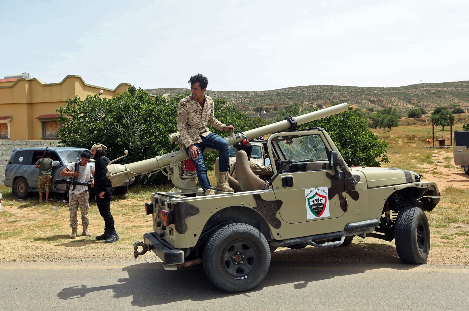 Fighters with Libya's UN-recognised Government of National Accord (GNA) gather at a position near the town of Garabulli, some 70 kms east of the capital Tripoli on April 19, 2020. (AFP)