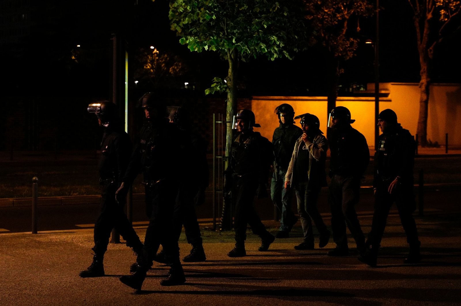 Plainclothes police and CRS anti-riot police officers walk in Villeneuve-la-Garenne, in the northern suburbs of Paris, early on April 20, 2020. (AFP Photo)