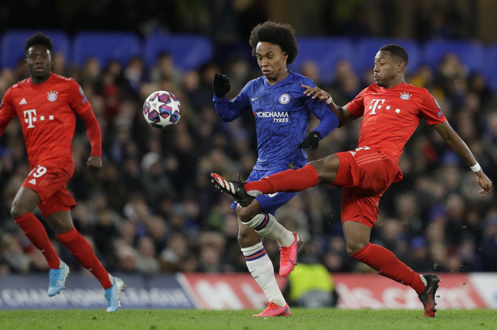 Bayern Munich's David Alaba challenges Chelsea's Willian during a Champions League match in London, England, Feb. 25, 2020. (AP Photo)