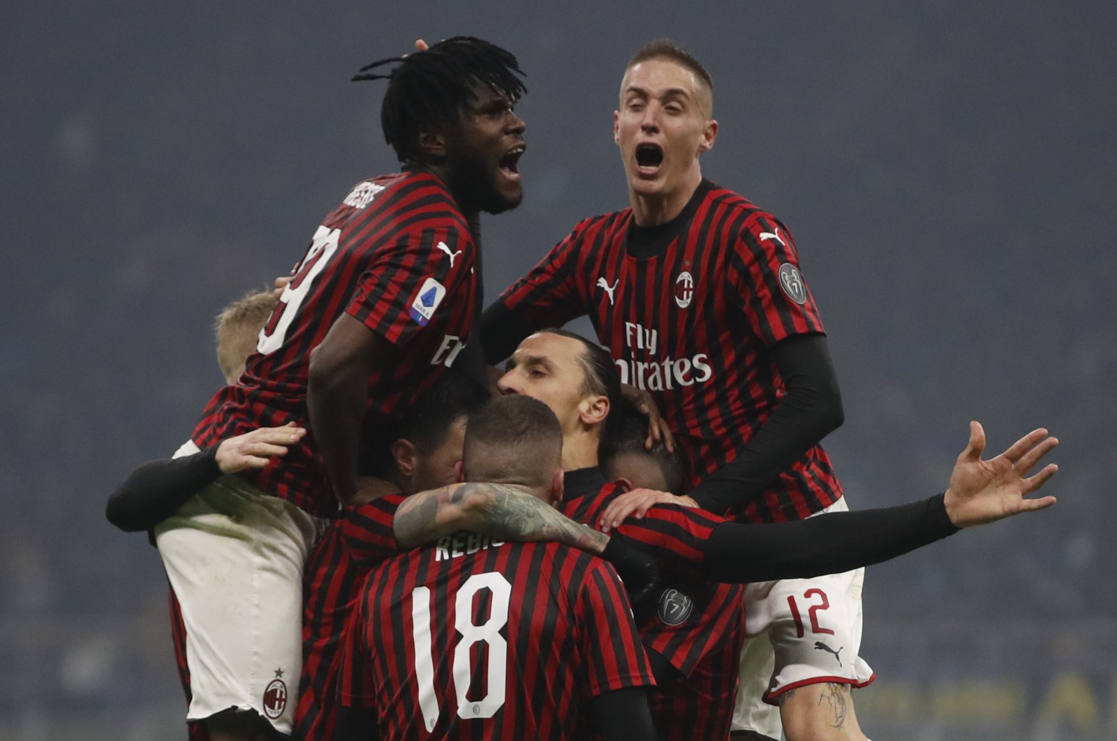 AC Milan's Zlatan Ibrahimovic (C) celebrates with his teammates after scoring his side's second goal during the Serie A match against Inter Milan, in Milan, Italy, Feb. 9, 2020. (AP Photo)