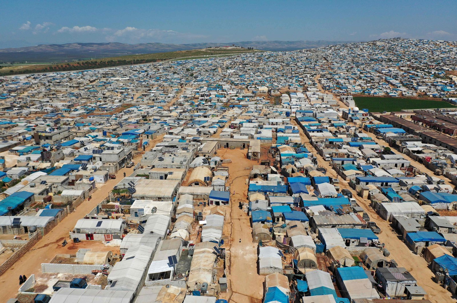 An aerial view shows the Atme camp for displaced Syrians close to the border with Turkey in Syria's northwestern Idlib province, on April 19, 2020. (AFP)