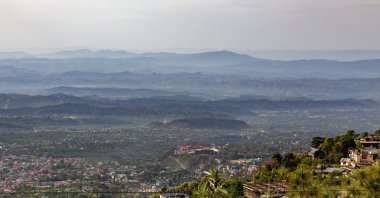 In this Friday, April 10, 2020, photo, Himachal Pradesh Cricket Association and the distant hills are clearly visible during lockdown to control the spread of the coronavirus in Dharmsala, India. (AP Photo)