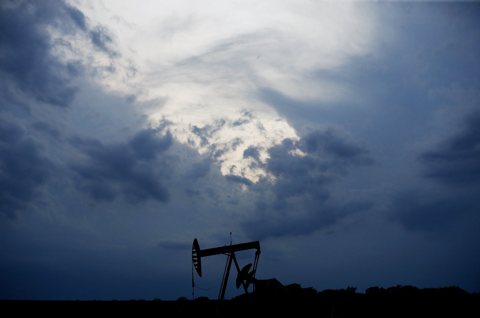 A pumpjack is pictured as a storm moves in Oklahoma City, Oklahoma, U.S., Tuesday, April 21, 2020. (AP Photo)