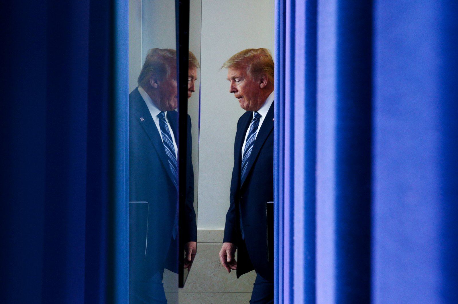 U.S. President Donald Trump arrives to lead the daily coronavirus task force briefing as seen from behind the backdrop of the Brady press briefing room at the White House in Washington, U.S., April 21, 2020. (Reuters Photo)