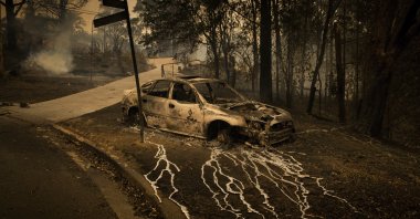 Aluminum, which melts at 660.3 C, has streamed from a burning car in Conjola Park, a town where bushfires razed more than 89 properties, in New South Wales, Australia, Dec. 31, 2019. (Matthew Abbott, Panos Pictures for The New York Times, World Press Photo via AP)
