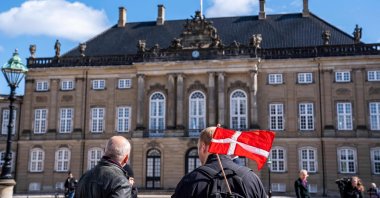 People are seen at Amalienborg Palace Square to mark the birthday of Danish Queen Margrethe in Copenhagen on April 16, 2020. (AFP Photo)