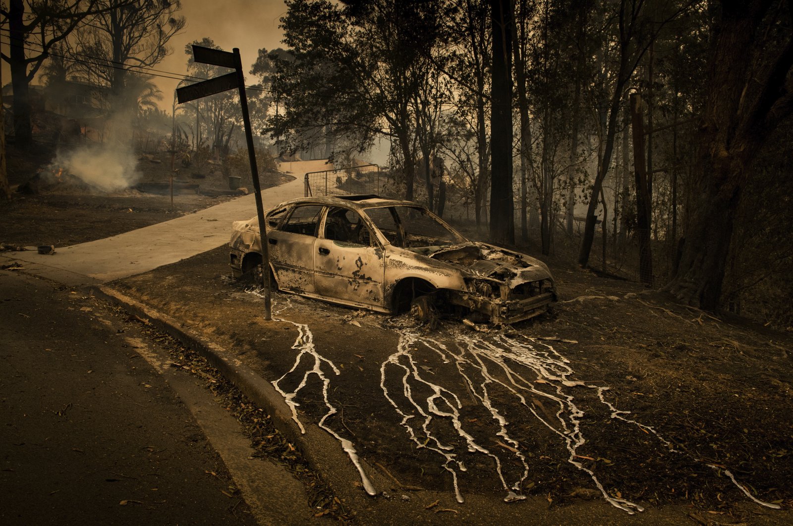 Aluminum, which melts at 660.3 C, has streamed from a burning car in Conjola Park, a town where bushfires razed more than 89 properties, in New South Wales, Australia, Dec. 31, 2019. (Matthew Abbott, Panos Pictures for The New York Times, World Press Photo via AP)