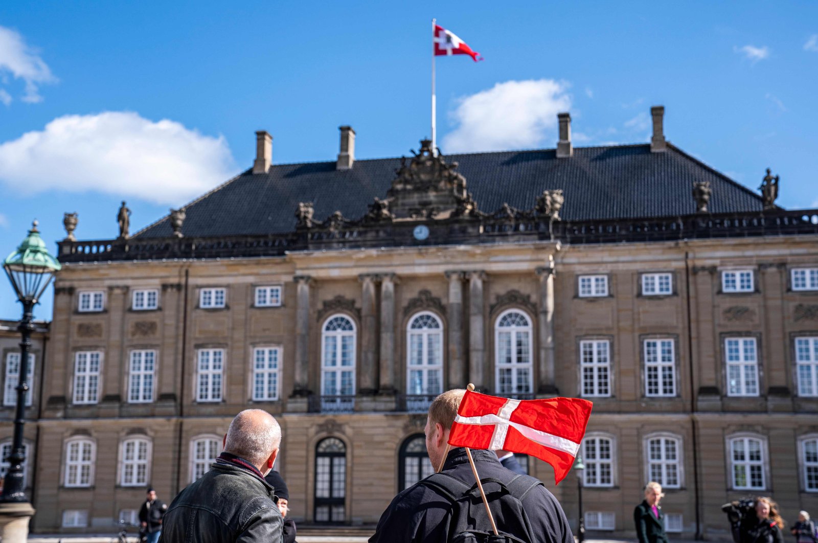 People are seen at Amalienborg Palace Square to mark the birthday of Danish Queen Margrethe in Copenhagen on April 16, 2020. (AFP Photo)