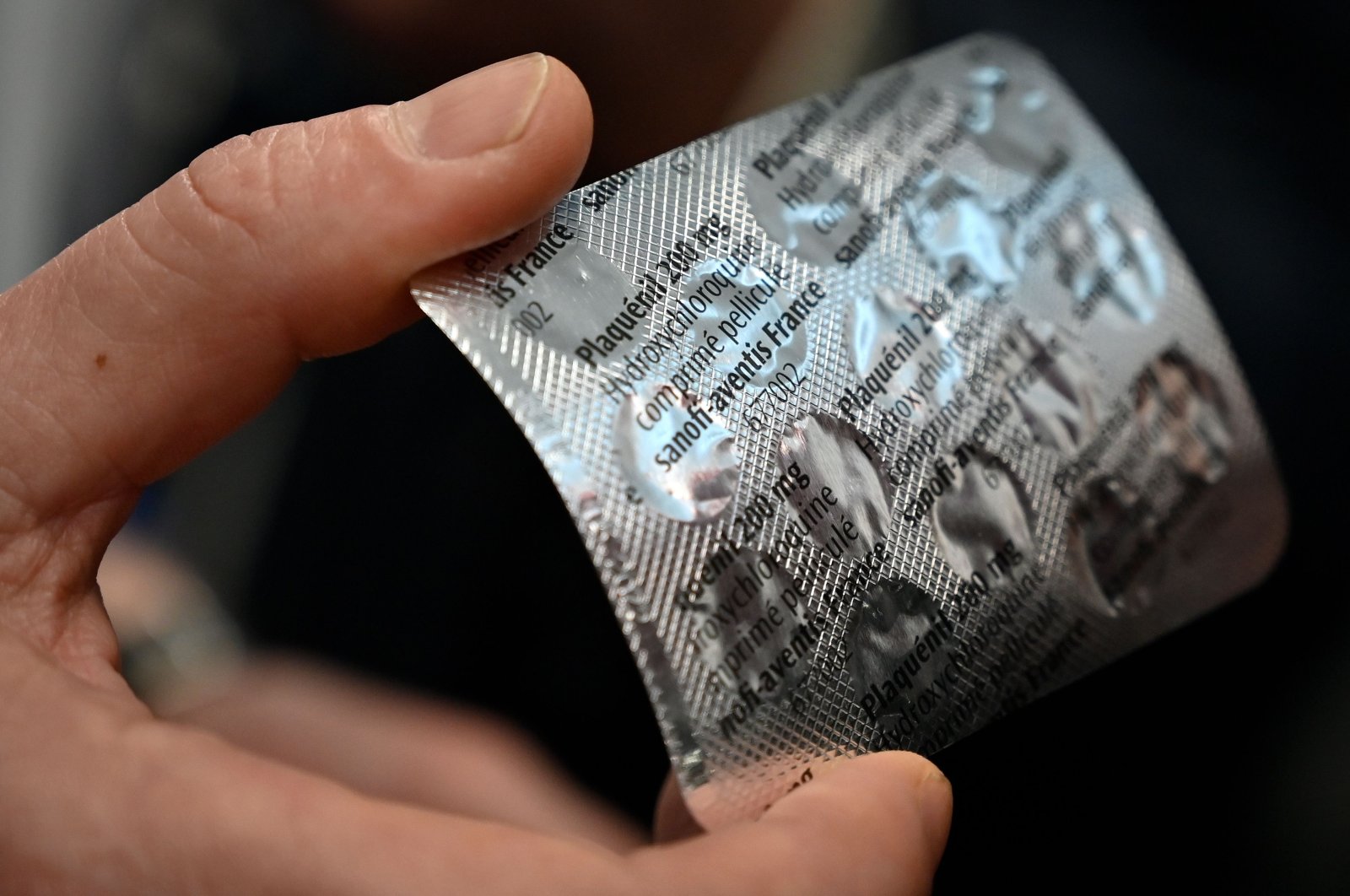 In this file photo taken on February 26, 2020, medical staff shows at the IHU Mediterranée Infection Institute in Marseille, a packet of Plaqueril, tablets containing hydroxychloroquine. (AFP Photo)