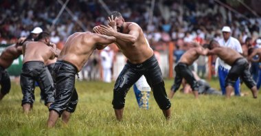 Two oil wrestlers are seen during a match held as part of the 658th Kırkpınar Oil Wrestling tournament at the Sarayiçi wrestling stadium, Edirne, Turkey, July 8, 2019. (DHA Photo).