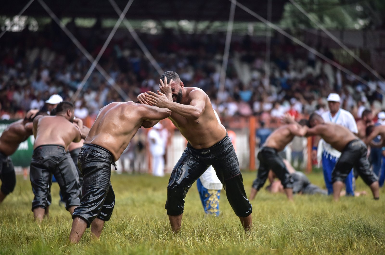 Two oil wrestlers are seen during a match held as part of the 658th Kırkpınar Oil Wrestling tournament at the Sarayiçi wrestling stadium, Edirne, Turkey, July 8, 2019. (DHA Photo).