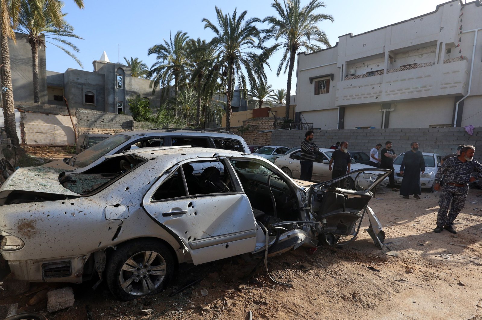 Libyans check the site of shelling on the residential area of souq al-Gomaa, north of the Libyan capital Tripoli, on April 17, 2020. (AFP Photo)