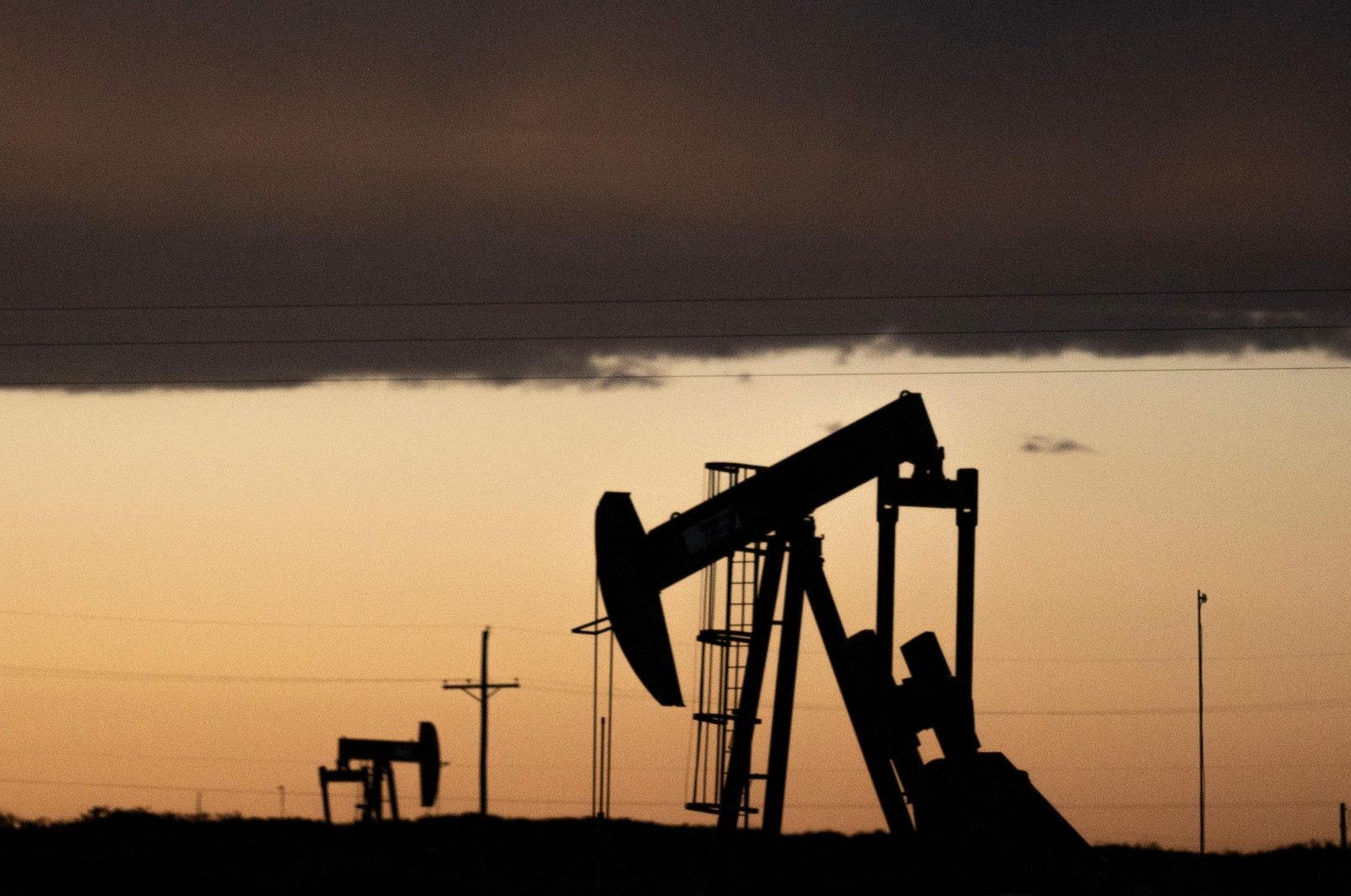 Pump jacks operate at dusk near Loco Hills in Eddy County, New Mexico, April 23, 2020. (AFP Photo)