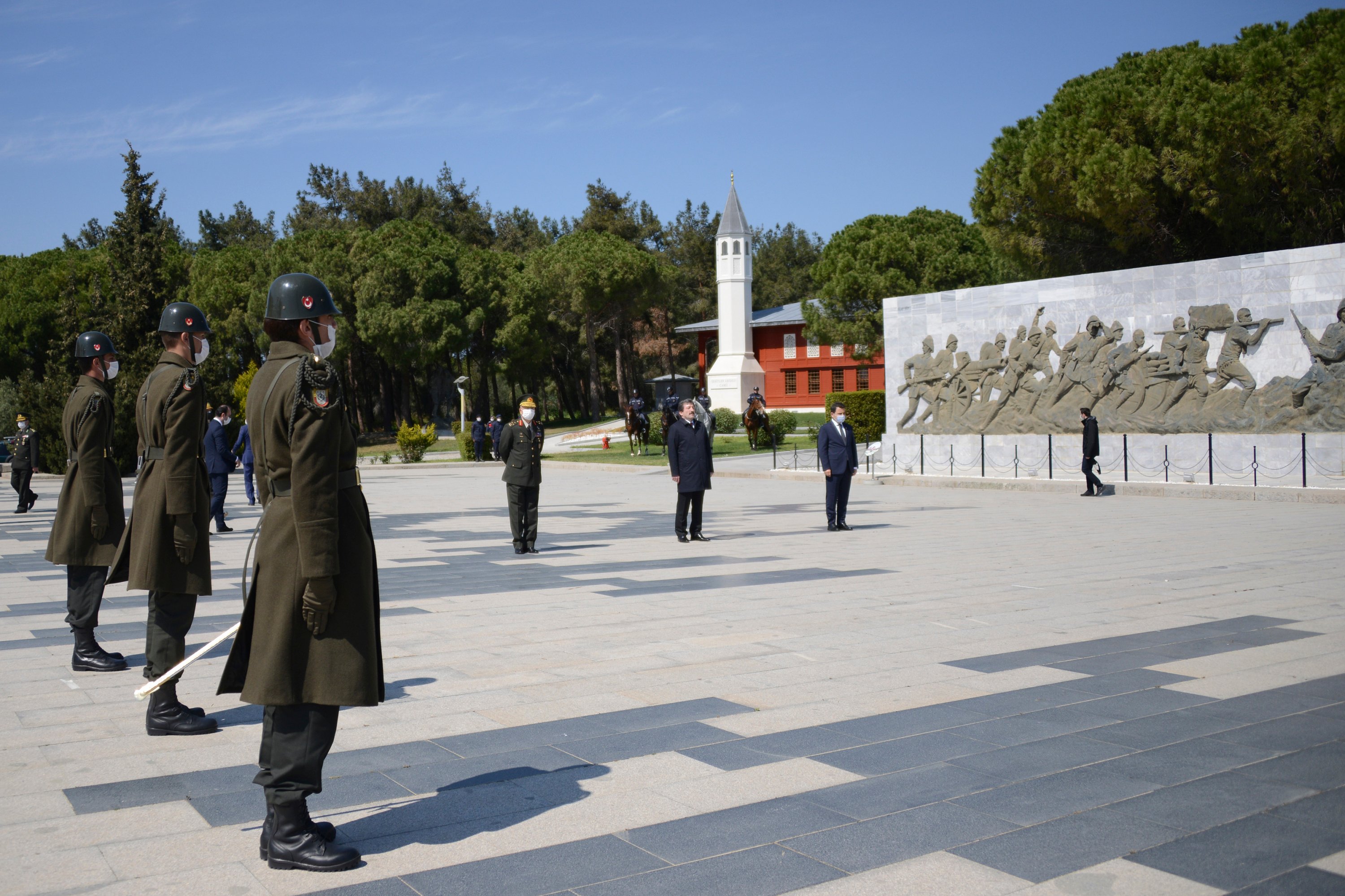 In this Friday, April 24, 2020, photo provided by the Çanakkale Governorate, few Turkish officials stand in respect at Turkish monument during the commemoration ceremonies.(Kadir Öztecik/Çanakkale Governorate via AP)
