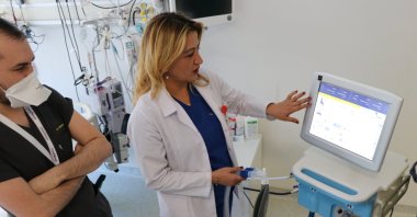 Sema Kultufan Turan (R), a member of Health Ministry's Coronavirus Science Board, tests the domestically made ventilator at a hospital in Ankara, Turkey, April 24, 2020. (AA Photo)
