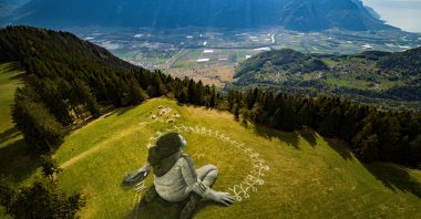 An artwork called "Beyond Crisis" by French artist Guillaume Legros aka Saype and created with an eco paint made out of chalk and coal over a 3,000-square-meter field is pictured during the coronavirus disease outbreak in Leysin, Switzerland, April 24, 2020. (Reuters Photo)
