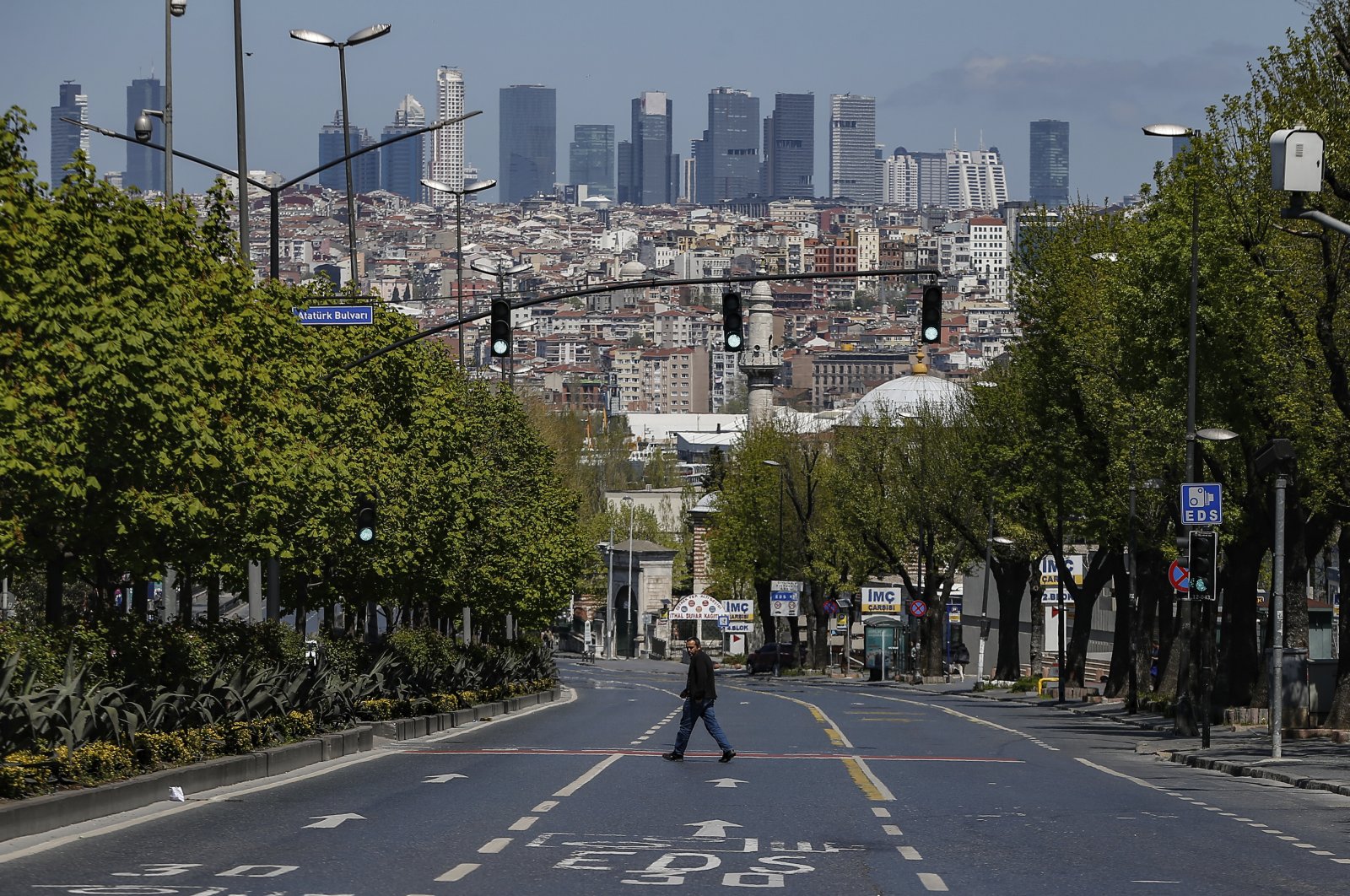 A man crosses a deserted road in Istanbul, during the first day of the holy fasting month of Ramadan, April 24, 2020. (AP Photo)