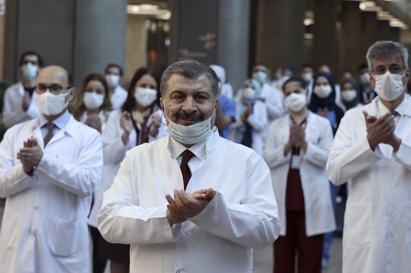 Turkish Health Minister Fahrettin Koca (C) and medical officials applaud during the inauguration ceremony for the Başakşehir City Hospital, a new massive health care complex partially opened to assist in the fight against the COVID-19 outbreak, in Istanbul, April 20, 2020. (AP Photo)