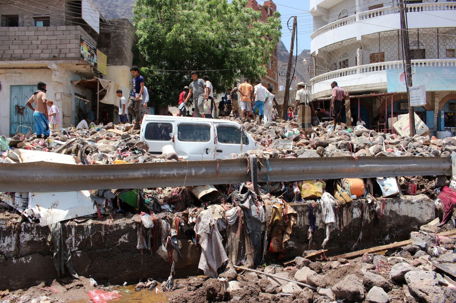 People inspect damage caused by floods on a street in Aden, Yemen, April 22, 2020. (Reuters Photo)