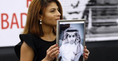 Ensaf Haidar, wife of the jailed Saudi Arabian blogger Raif Badawi, shows a portrait of her husband as he is awarded the Sakharov Prize, in Strasbourg, France, Dec. 16, 2015. (AP Photo)