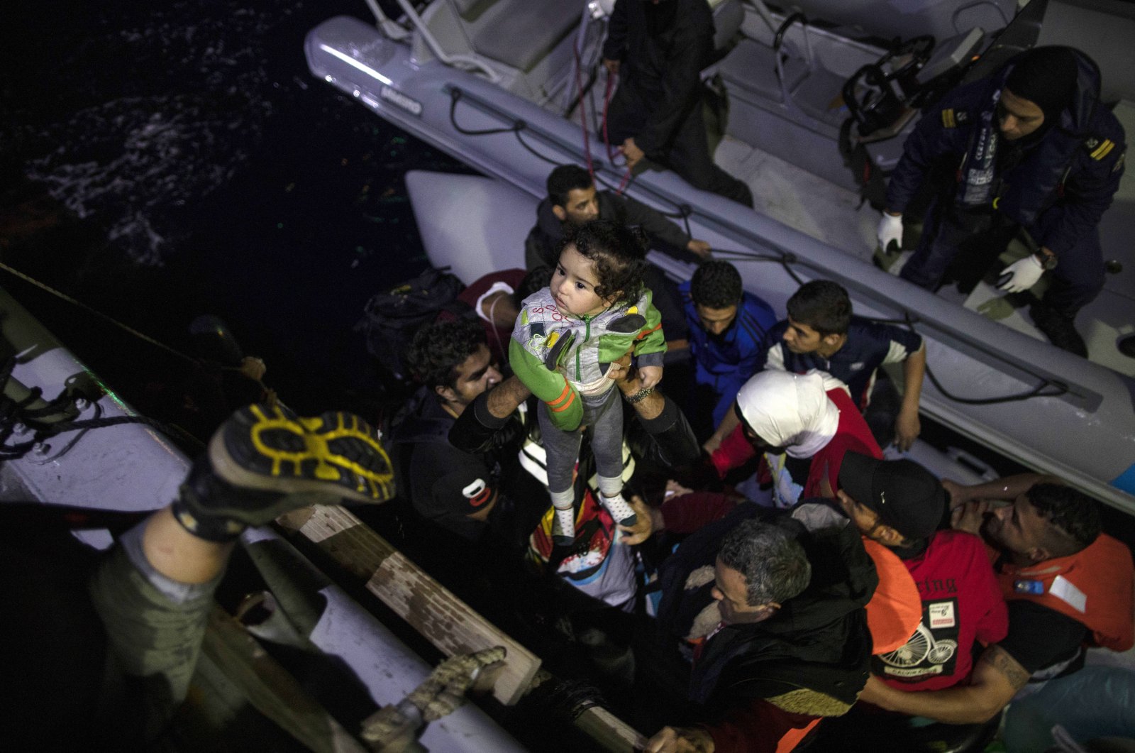 Refugees and migrants board a coast guard ship during a rescue operation on Sept. 26, 2019, near the Greek island from Samos. (AP Photo)