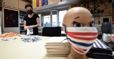 A seamstress from the Opera de Marseille makes face masks out of fabric in the sewing workshop of the Marseille opera house, April 20, 2020, in Marseille, southeastern France. (AFP Photo)