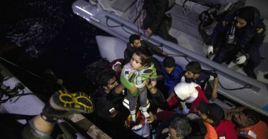 Refugees and migrants board a coast guard ship during a rescue operation, Sept. 26, 2019, near the Greek island of Samos. (AP Photo)