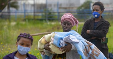 African refugees in the Tunisian capital Tunis wait in line for aid handouts, April 23, 2020 (AA Photo)