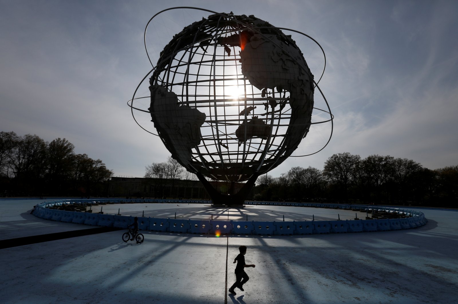 A child plays under "The Unisphere" in Flushing Meadows-Corona Park during the outbreak of the coronavirus disease in the Queens borough of New York City, New York, U.S., April 25, 2020. (Reuters Photo)