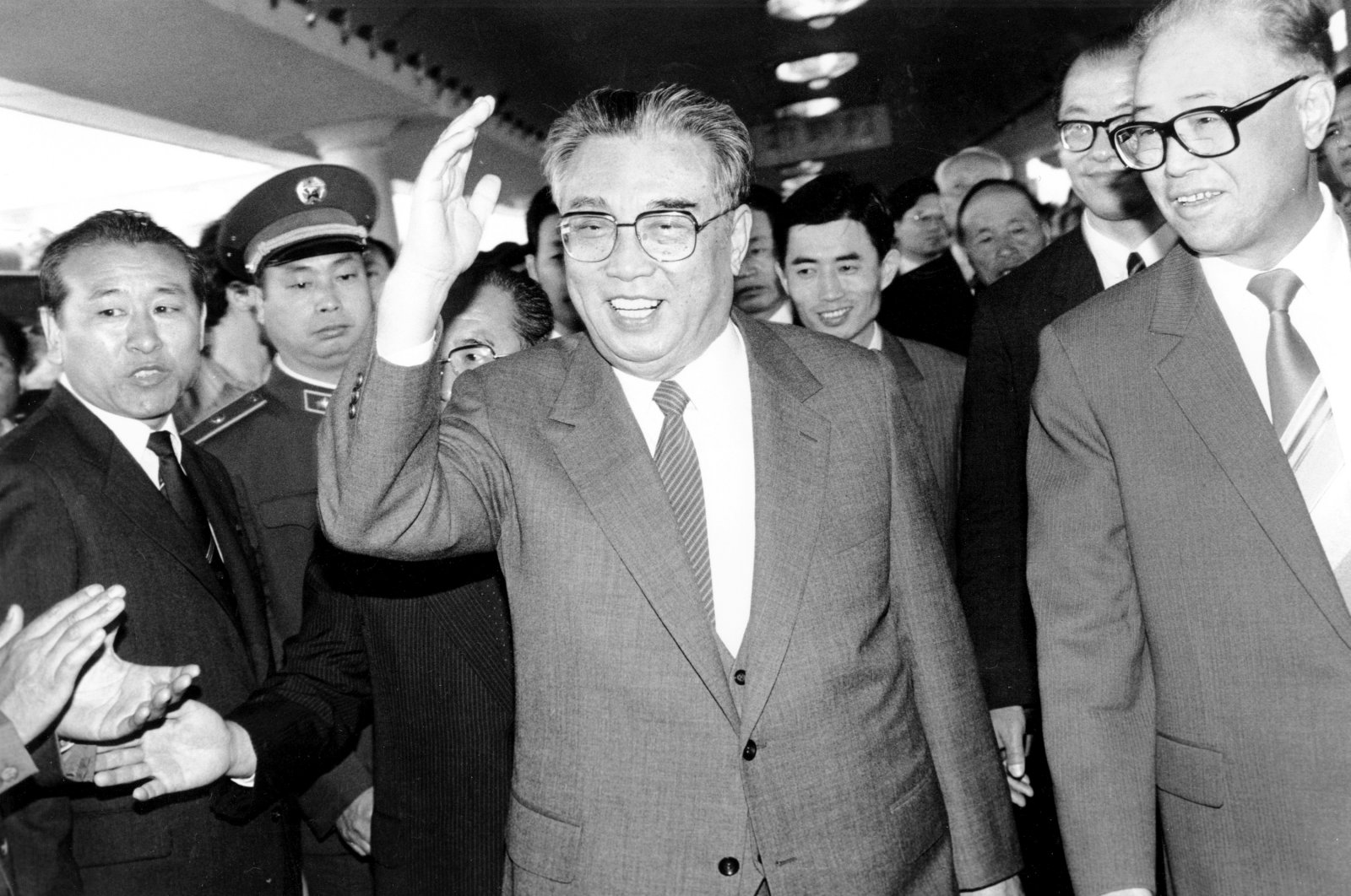 In this May 21, 1987, file photo, then North Korean President Kim Il Sung, center, and then Chinese Premier Zhao Ziyang make their way through a crowd of well-wishers at the train station in Beijing. (AP Photo)