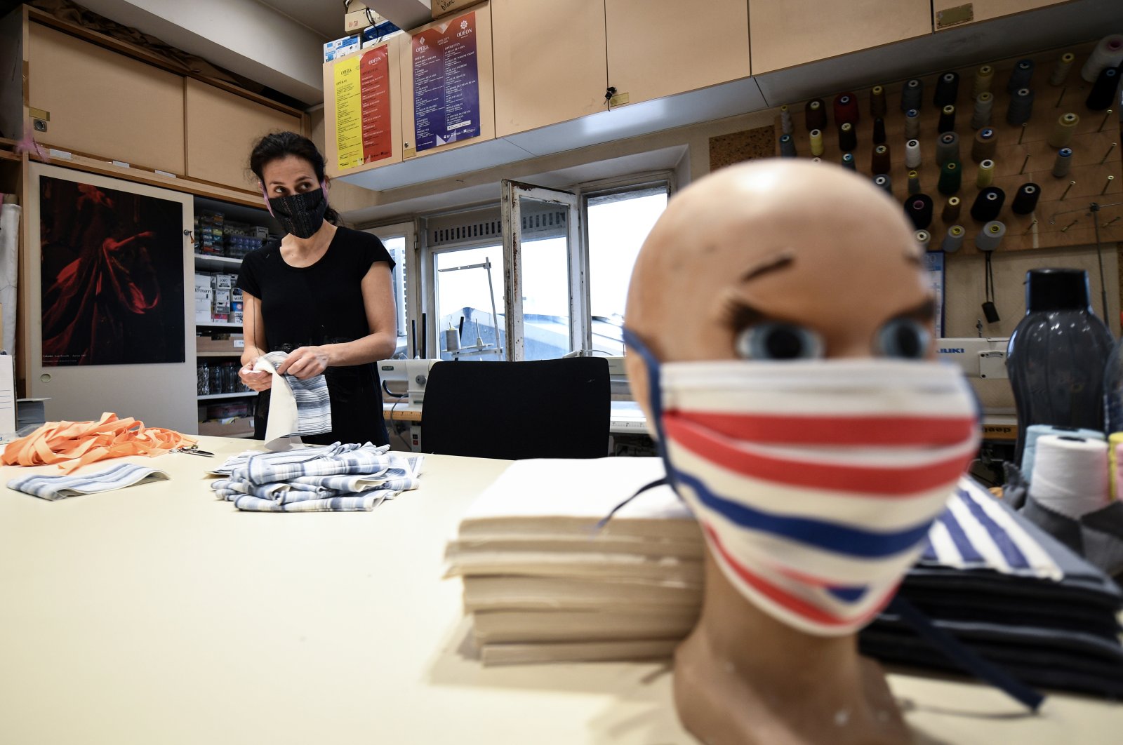 A seamstress from the Opera de Marseille makes face masks out of fabric in the sewing workshop of the Marseille opera house, April 20, 2020, in Marseille, southeastern France. (AFP Photo)