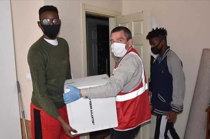 A social services worker delivers aid to university students from African countries who were stranded in Kars, Turkey, in this undated photo. (AA Photo) 
