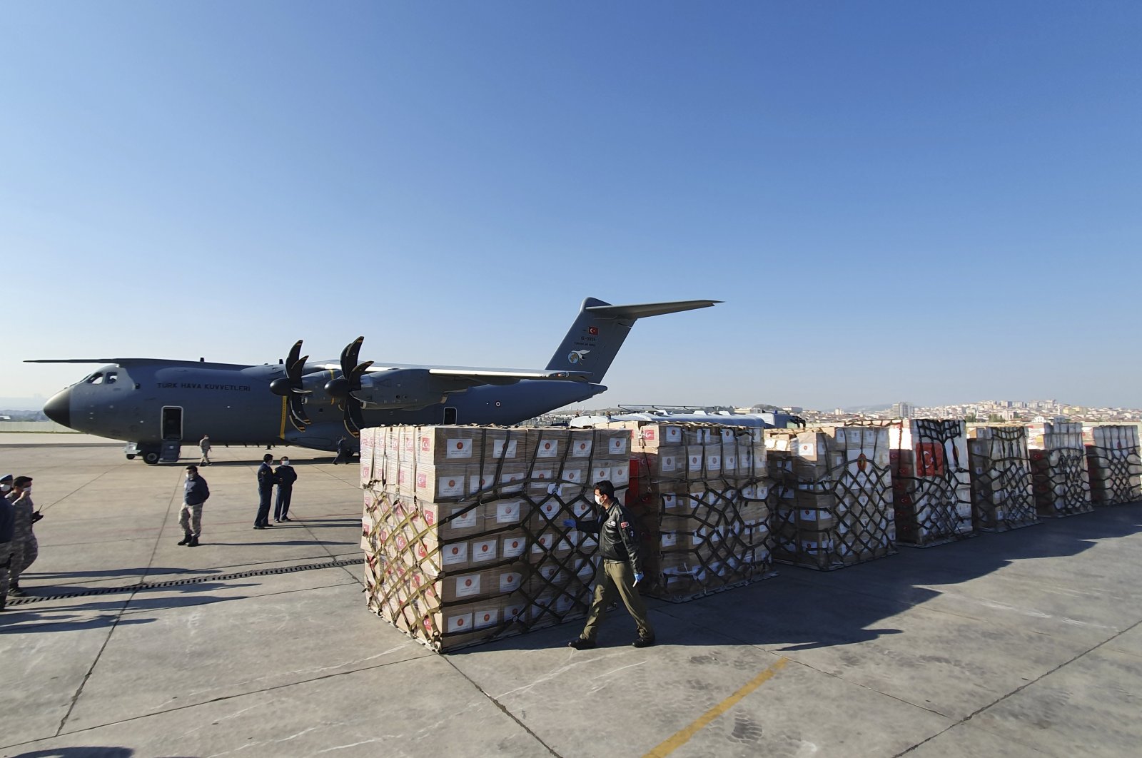 In this handout photo provided by the Turkish Defense Ministry, Turkish soldiers prepare to load a military cargo plane with Personal Protection Equipment donated by Turkey to help United States combat the new coronavirus outbreak, at the Etimesgut airport outside Ankara, Turkey, Tuesday, April 28, 2020. (AP Photo)