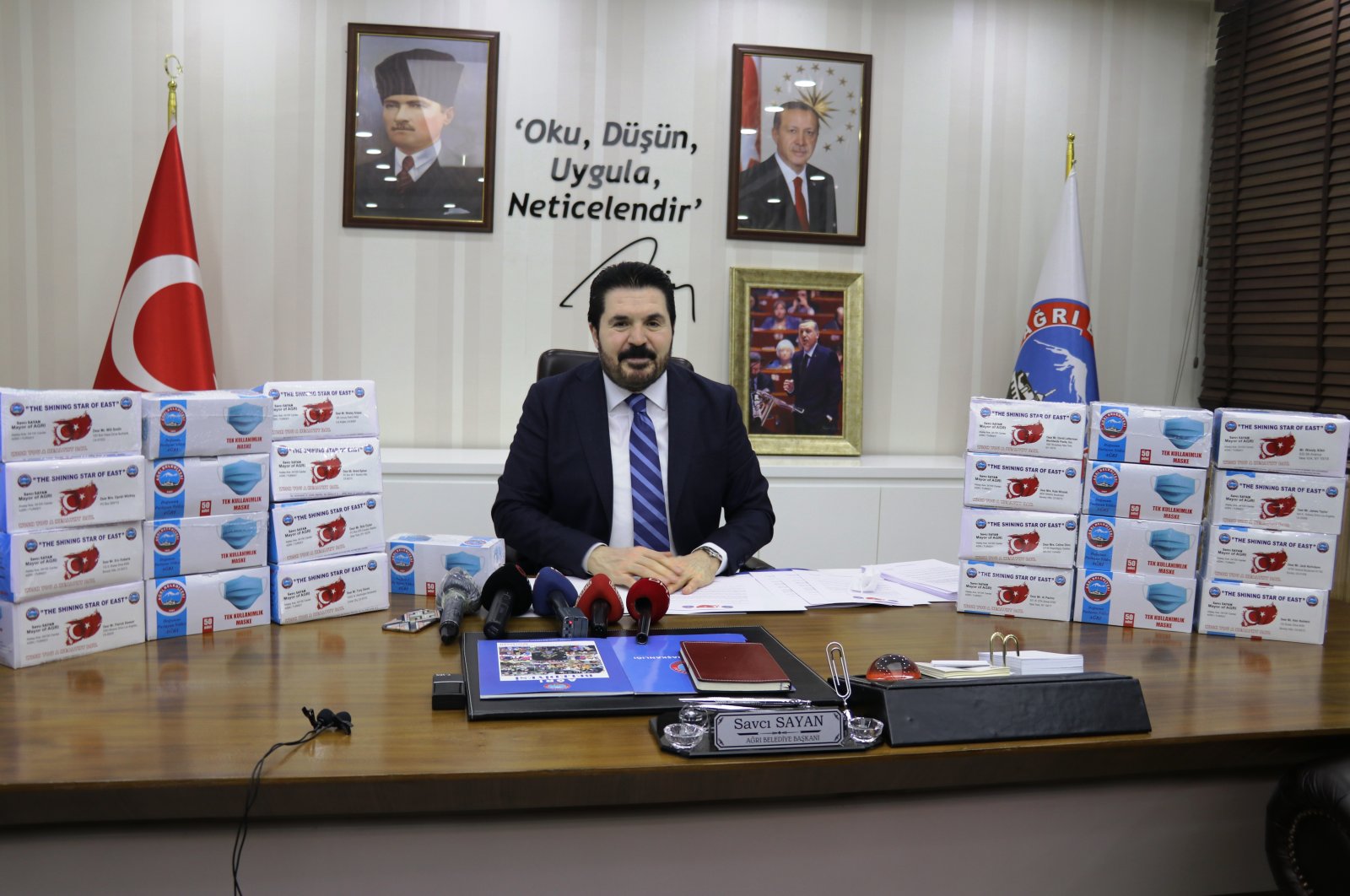 Ağrı Mayor Savcı Sayan poses with the boxes of masks to be sent to U.S., in northeastern Ağrı province, Turkey, April 28, 2020. (AA Photo)