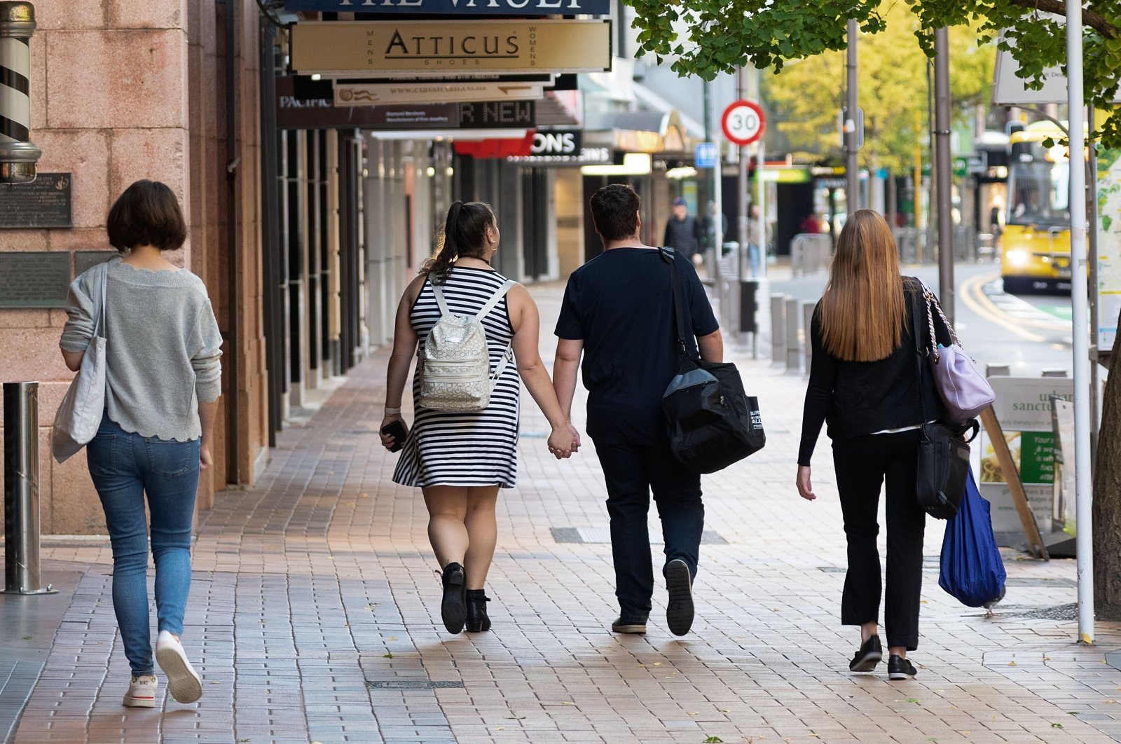 People walk down a street on the first day of the easing of restrictions, Wellington, New Zealand, April 28, 2020. (AFP Photo)
