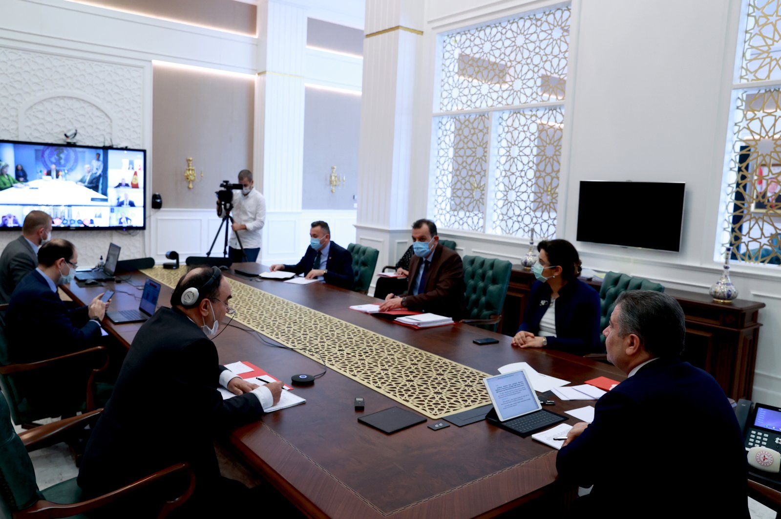 Turkish Health Minister Fahrettin Koca (R) and other officials attend to the videoconference held between counterparts from the Turkic Council, in Ankara, on April 28, 2020. (AA Photo)