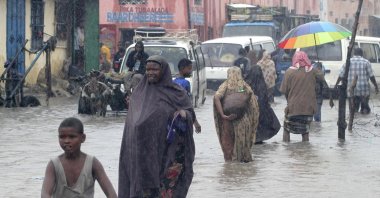 Residents wade through a flooded street in the Hamar Jajab district of the capital Mogadishu, Somalia, July 14, 2011. (Reuters Photo)