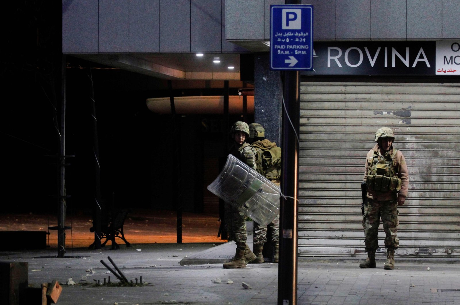 Lebanese troops take cover amid overnight confrontations with protesters in the southern city of Sidon (Saida), Lebanon, April 28, 2020. (AFP Photo)