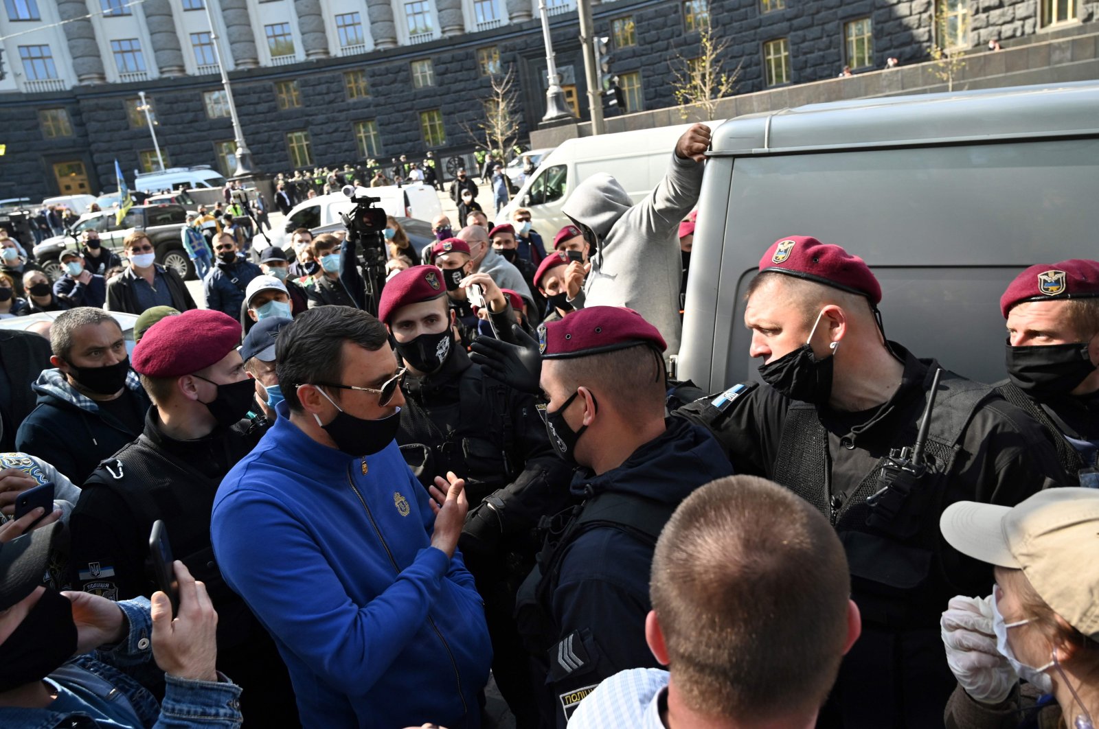 Protesters argue with riot police during a rally of small business representatives demanding to ease the coronavirus lockdown measures in front of the Cabinet of Ministers of Ukraine in downtown Kyiv on April 29, 2020. (AFP Photo)