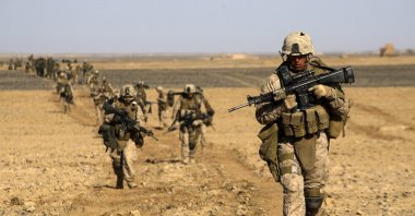 U.S. Marines from 3rd Battalion, 6th Marine Regiment walk in a column as they enter Marjah in Afghanistan's Helmand province Saturday, Feb. 13, 2010. (AP Photo)