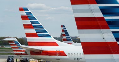 A member of a ground crew walks past American Airlines planes parked at the gate during the coronavirus outbreak at Ronald Reagan National Airport in Washington, U.S., April 5, 2020. (Reuters Photo)
