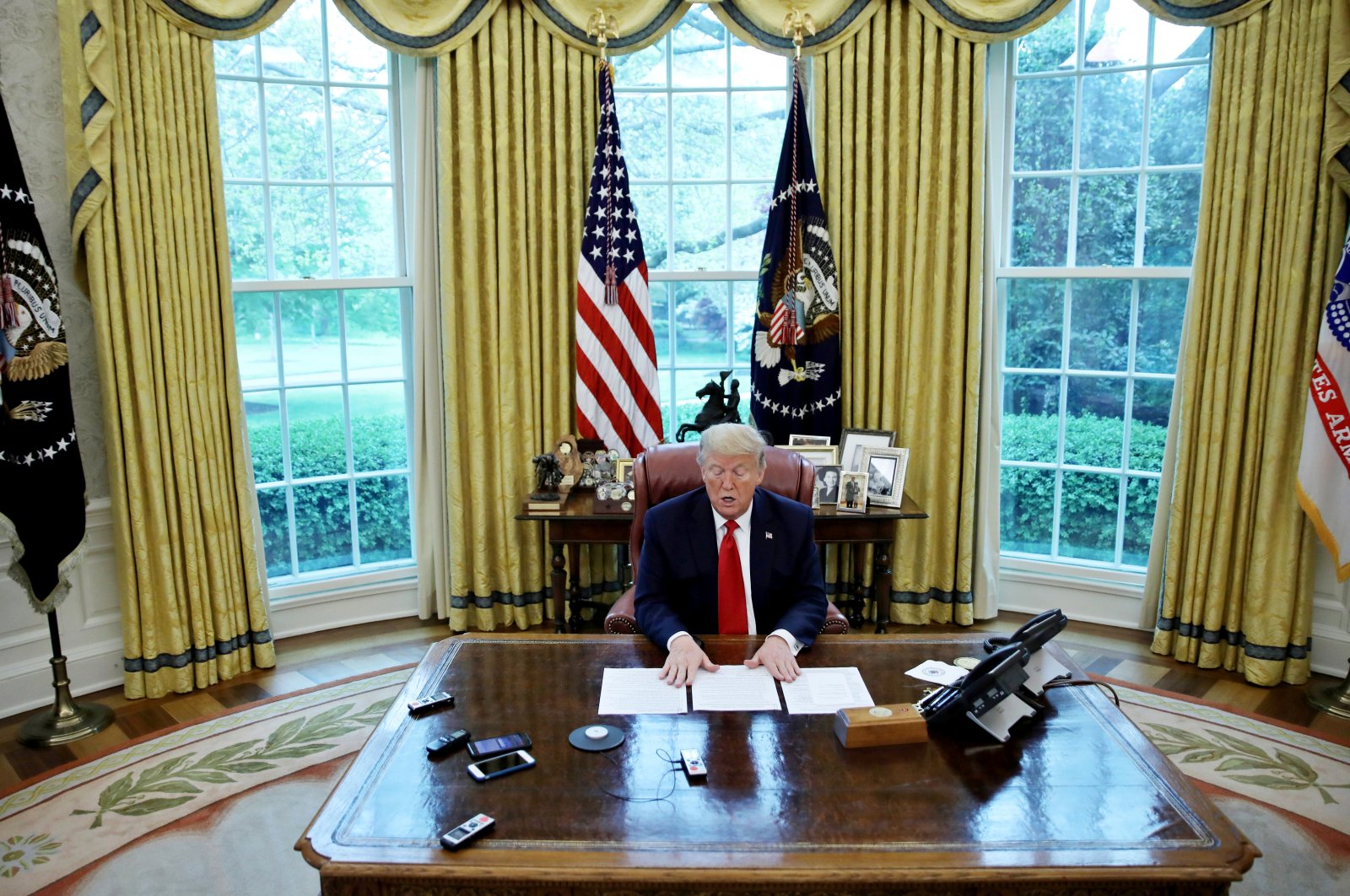 U.S. President Donald Trump looks at his briefing papers in the Oval Office of the White House, Washington, D.C., U.S., April 29, 2020. (REUTERS Photo)