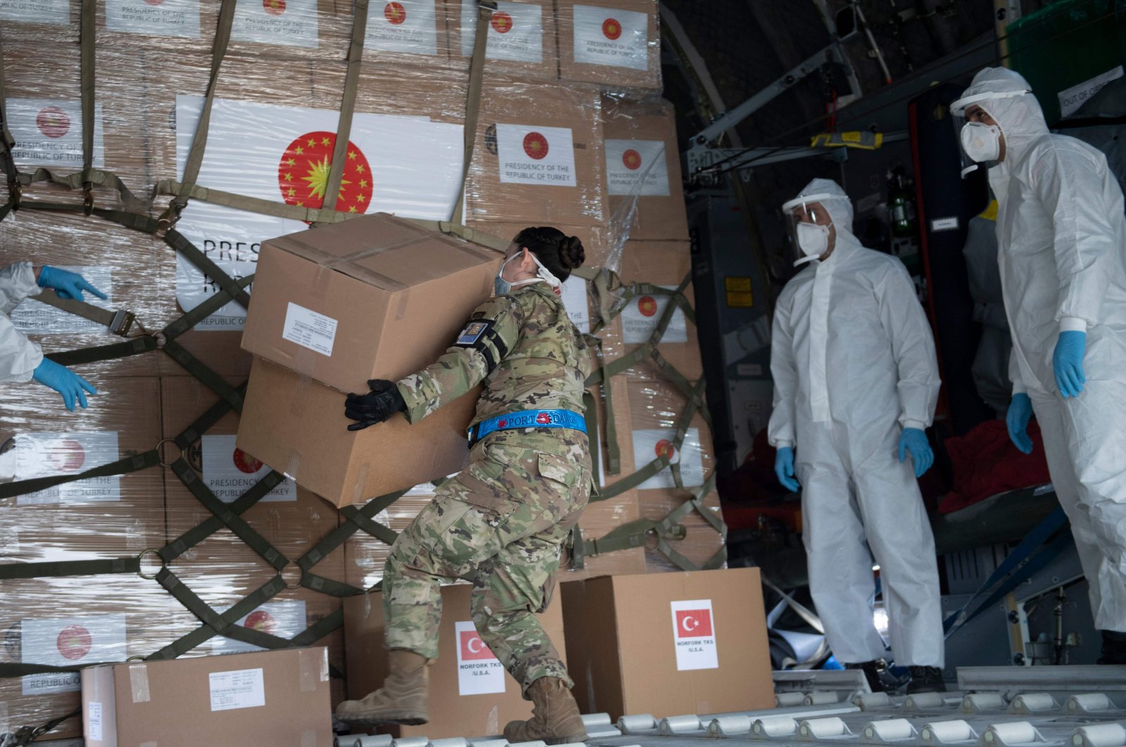 A Turkish military cargo plane with medical supplies and protective equipment to combat COVID-19 in the US is unloaded at Andrews Air Force Base, April 28, 2020, in Maryland. (AFP Photo)