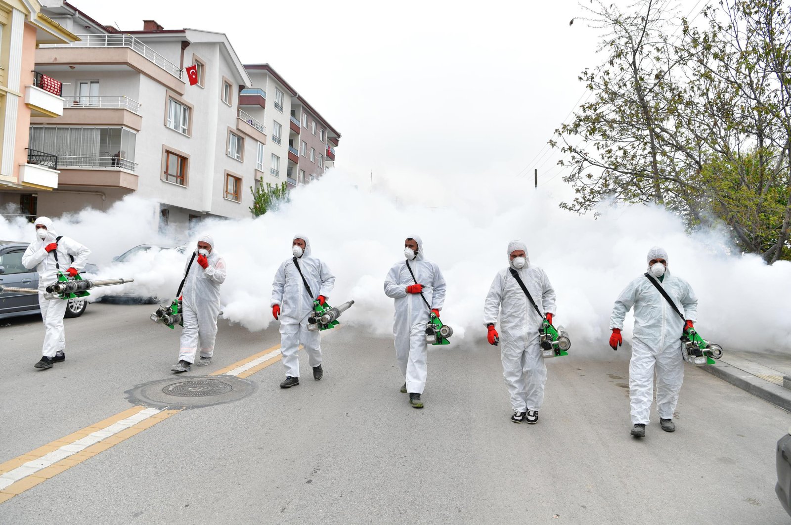 Municipality workers spray disinfectant on a street in Mamak district in Ankara, Turkey, April 30, 2020. (DHA Photo)